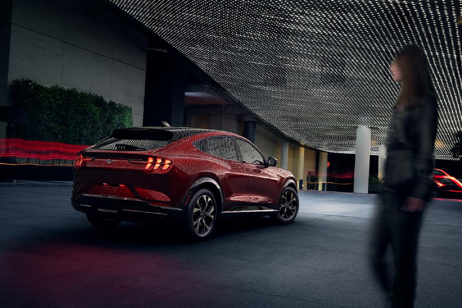 The rear 3/4 view of a red 2021 Ford Mustang Mach-E Premium