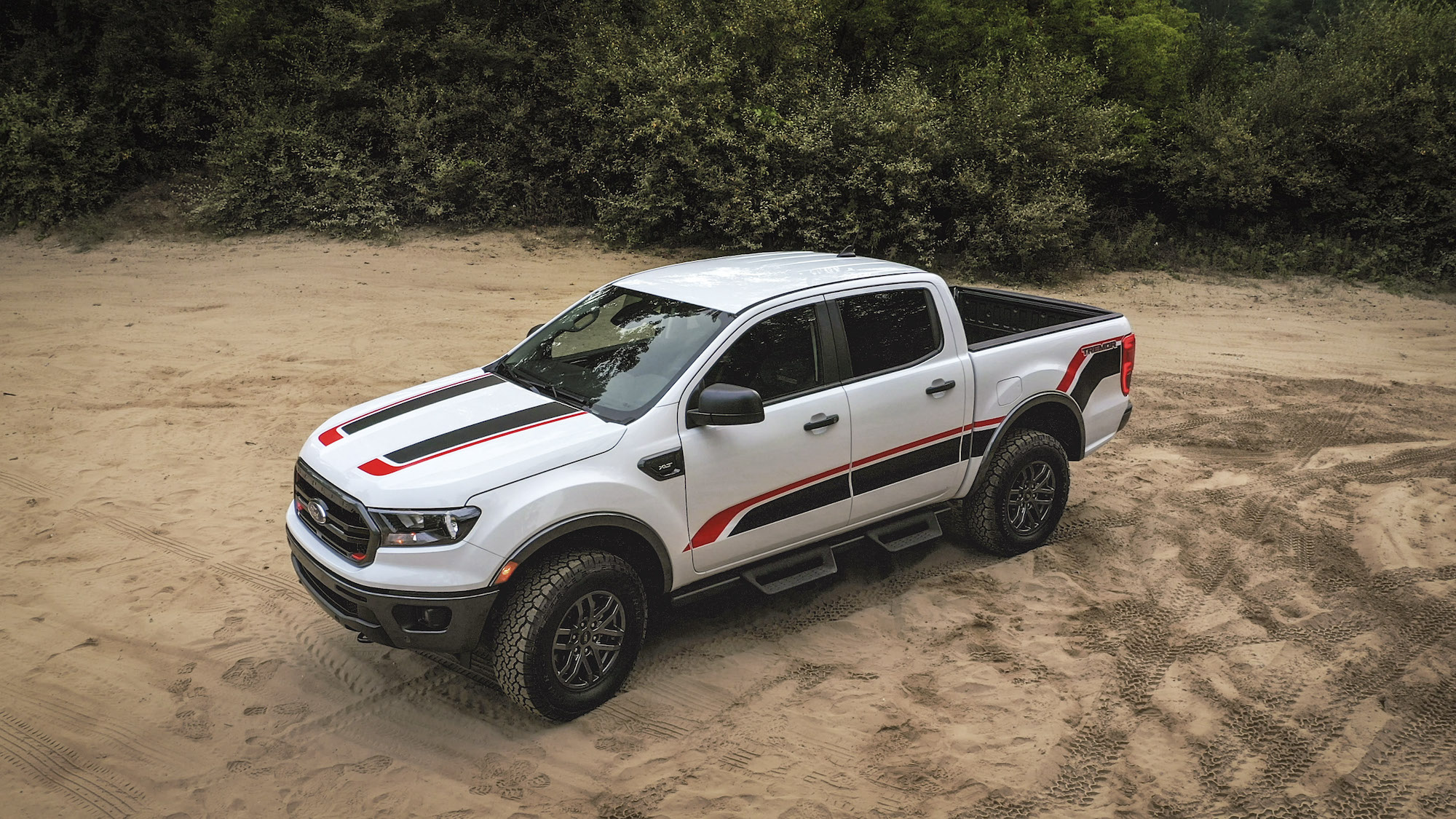A white 2021 Ford Ranger Tremor XLT off-road pickup truck with black and red sticker details