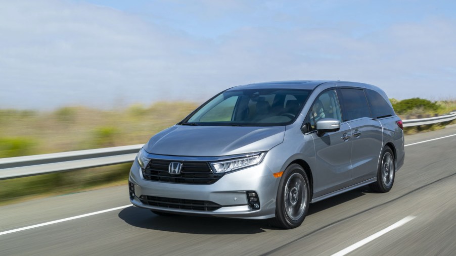 The 2021 Honda Odyssey driving down an empty road