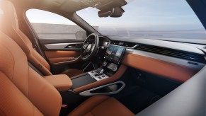 A2021 Jaguar F-Pace luxury compact SUV's tan cockpit