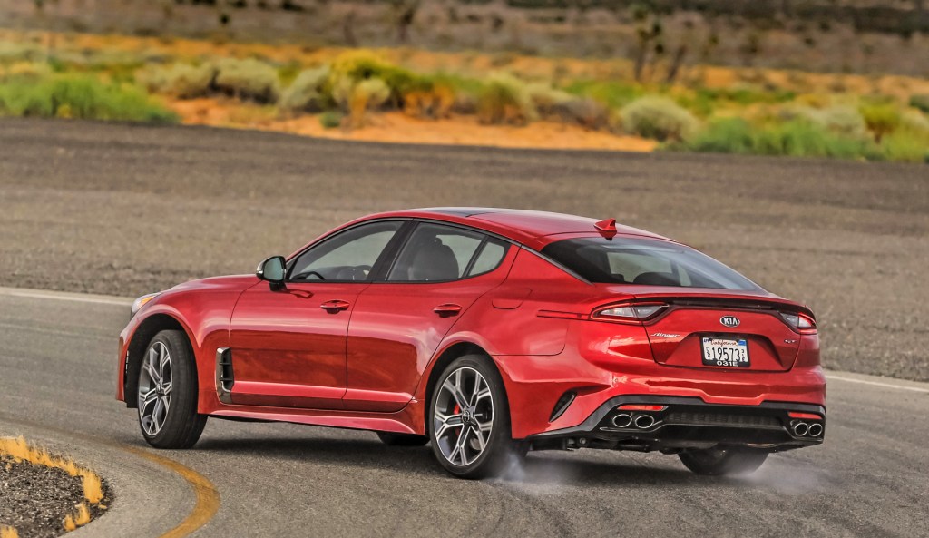 A red 2021 Kia Stinger GT2 driving down a race track