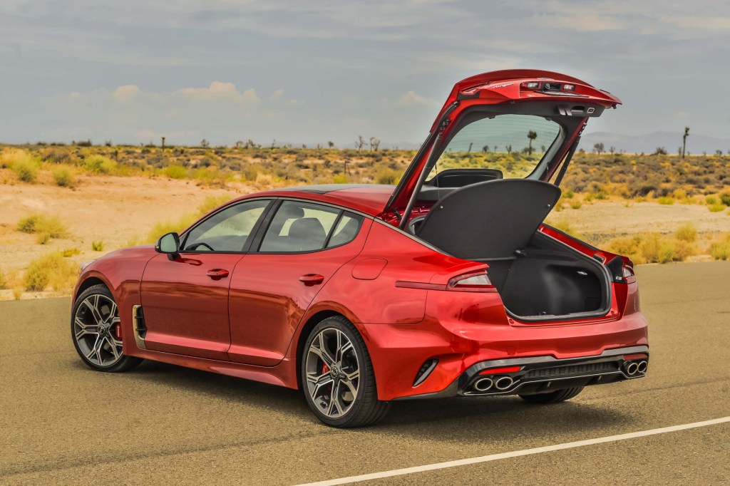 A red 2021 Kia Stinger GT2 parked with its rear hatch open