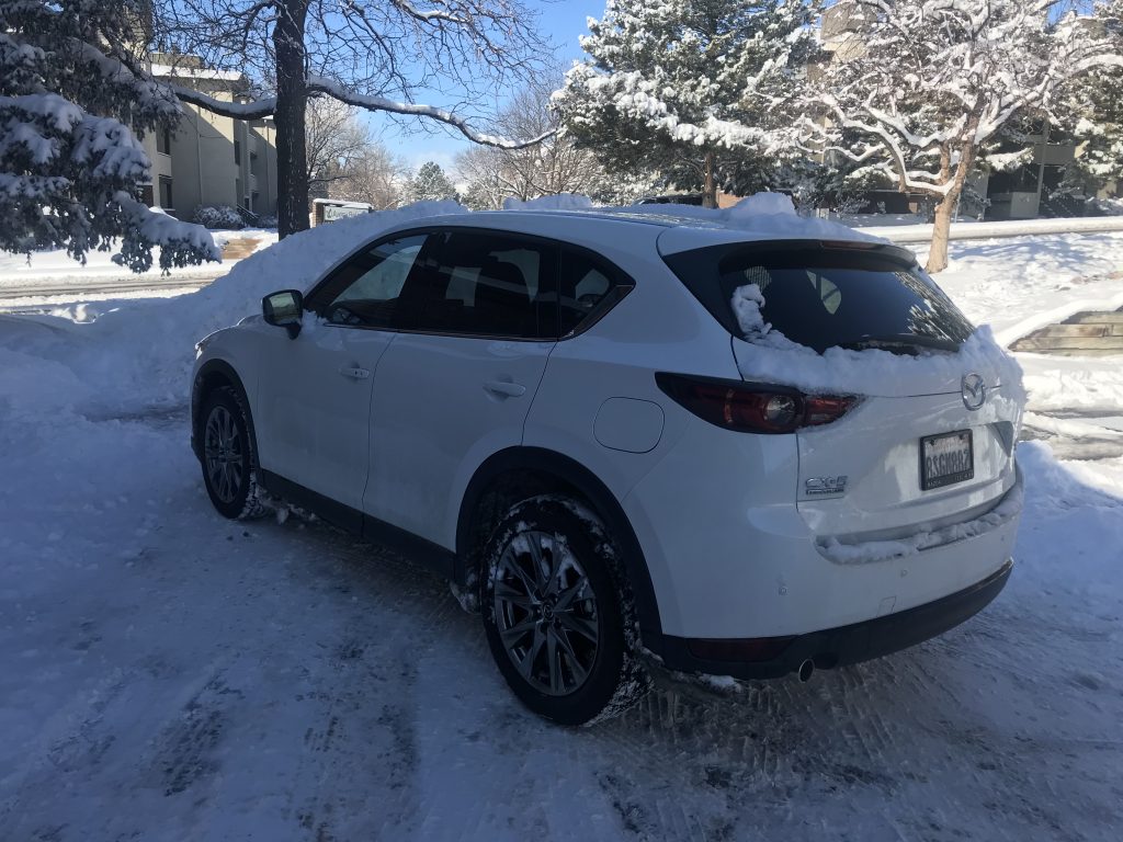 A rear shot of the 2021 Mazda CX-5 in the snow the day after a snowfall