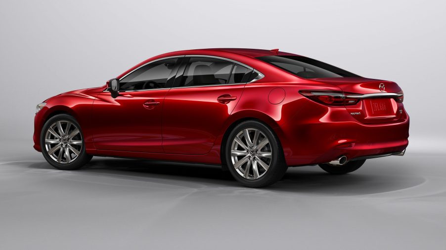 A red 2021 Mazda6 on display, facing away from the camera