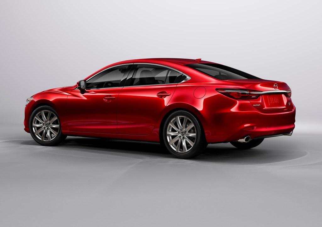 A red 2021 Mazda6 on display, facing away from the camera