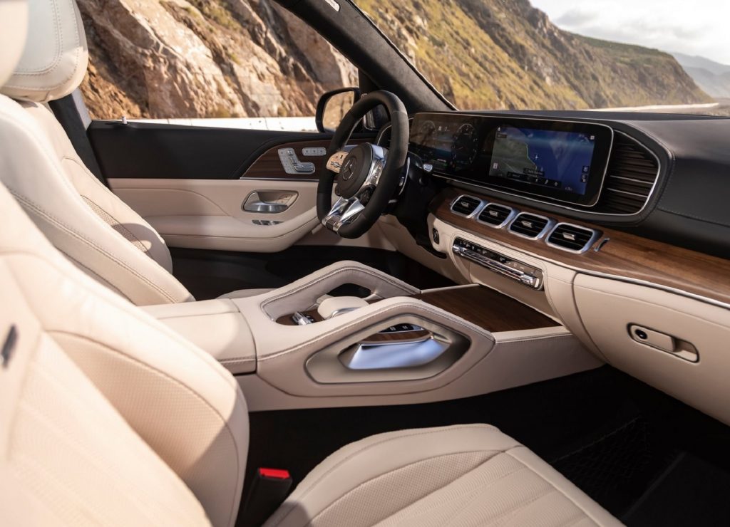The white-leather front seats and wood-trimmed dashboard of the 2021 Mercedes-AMG GLS 63