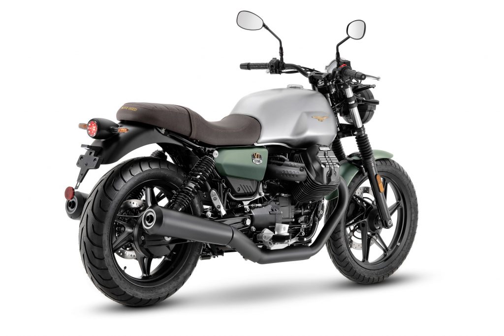 The rear 3/4 view of the silver-and-green 2021 Moto Guzzi V7 Stone Centenario