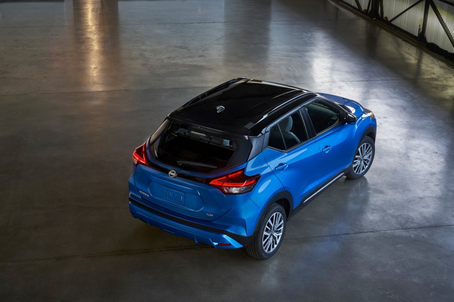 An electric-blue 2021 Nissan Kicks parked in a warehouse