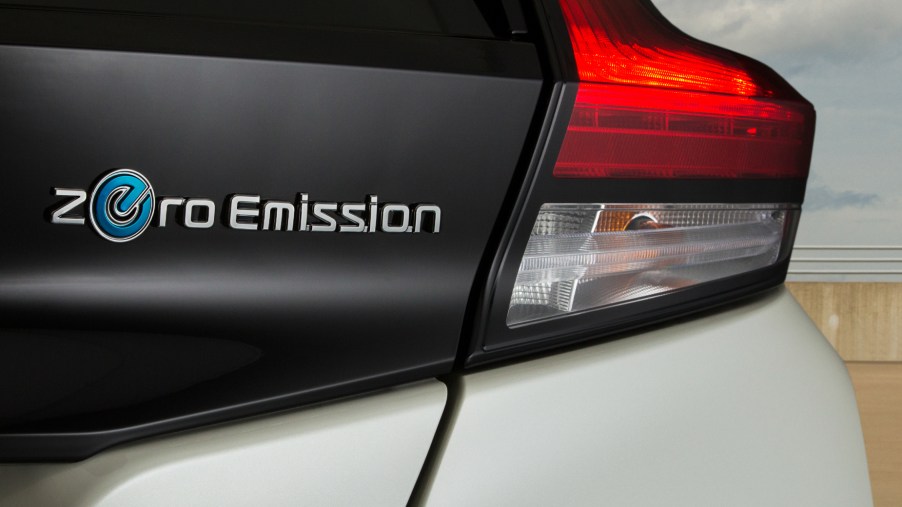 A look at the "Zero Emission" tag next to the taillgith of a white 2021 Nissan Leaf