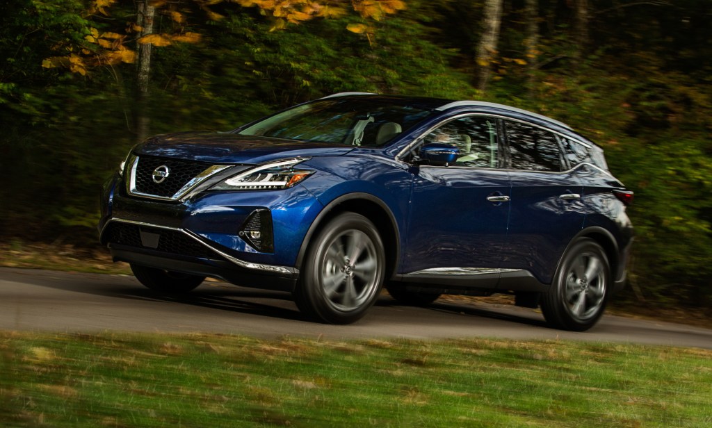 A blue 2021 Nissan Murano driving down a country road