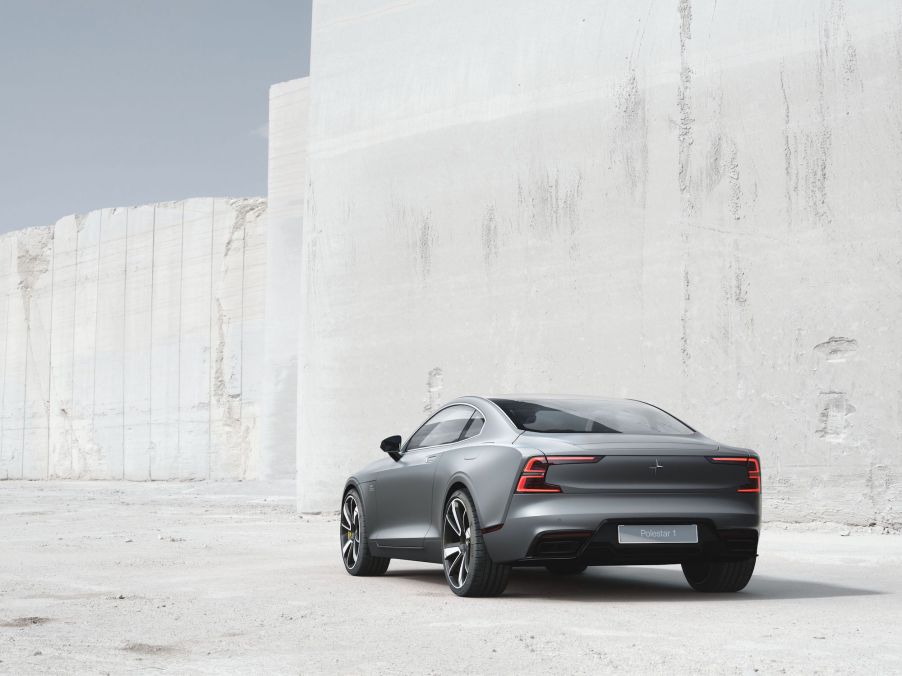 A silver 2021 Polestar 1 coupe parked in front of a whitewashed wall