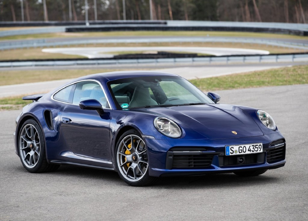 A blue 2021 Porsche 911 Turbo S parked on a racetrack