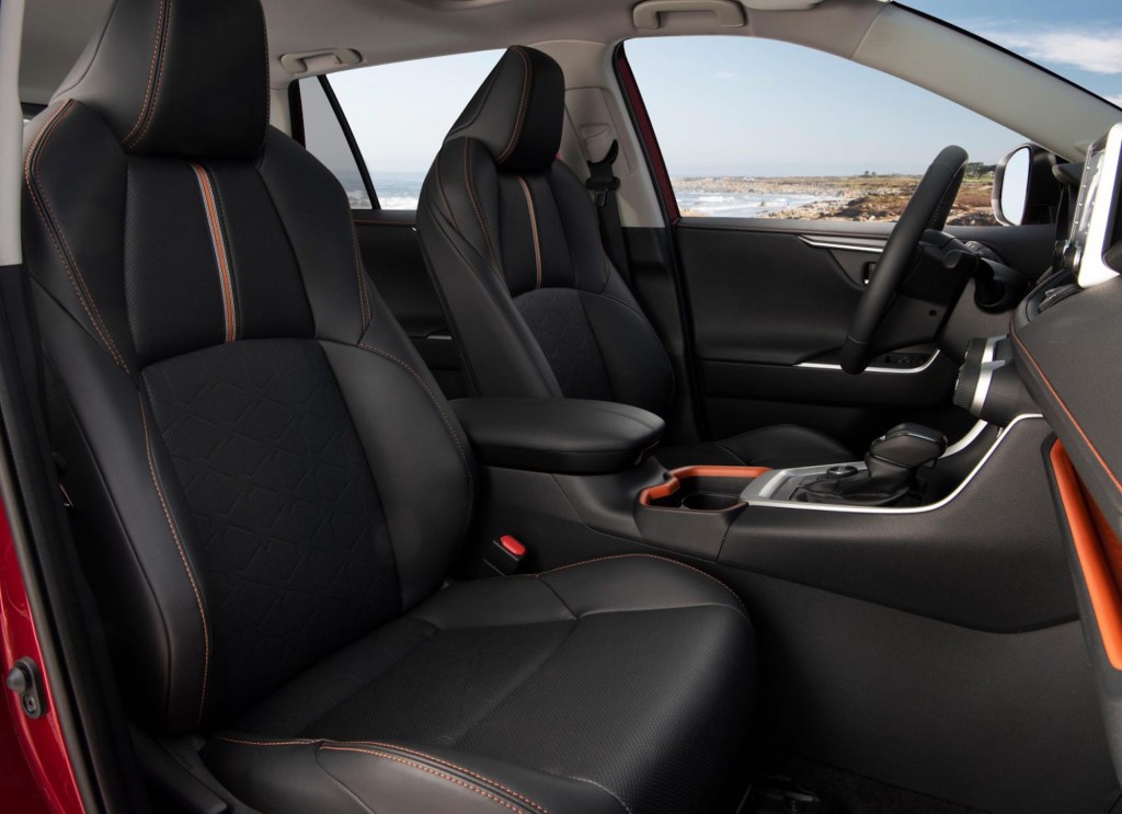 The black leatherette front seats of a 2021 Toyota RAV4 Adventure model with red accents