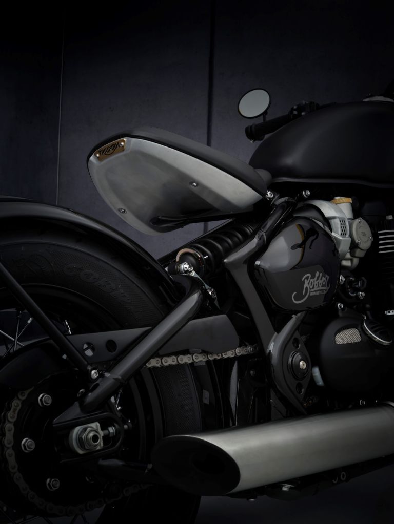 The rear view of the solo seat and frame of a matte-gray-and-brown 2021 Triumph Bonneville Bobber