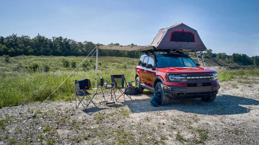 2021 Ford Bronco Sport in a feild wearing the new Camp themed accessories bundle with built in roof tent