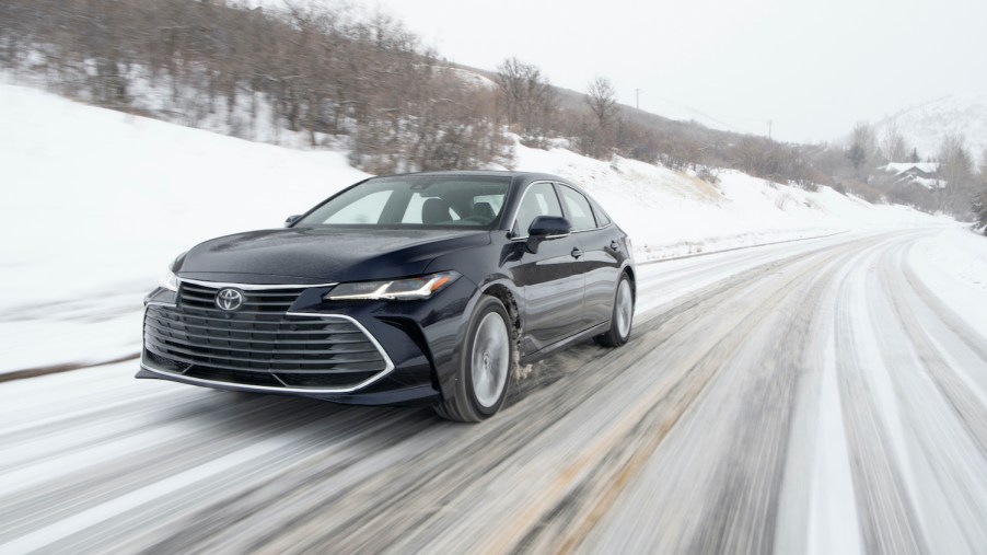 The 2021 Toyota Avalon driving down a snow covered road