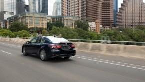 The 2021 Toyota Camry driving down the road