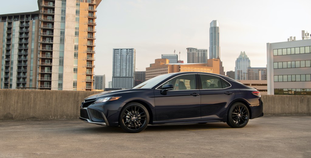 The Toyota Camry parked in front of a city skyline