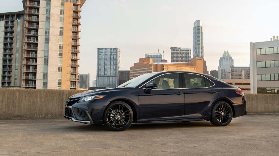 The Toyota Camry parked in front of a city skyline