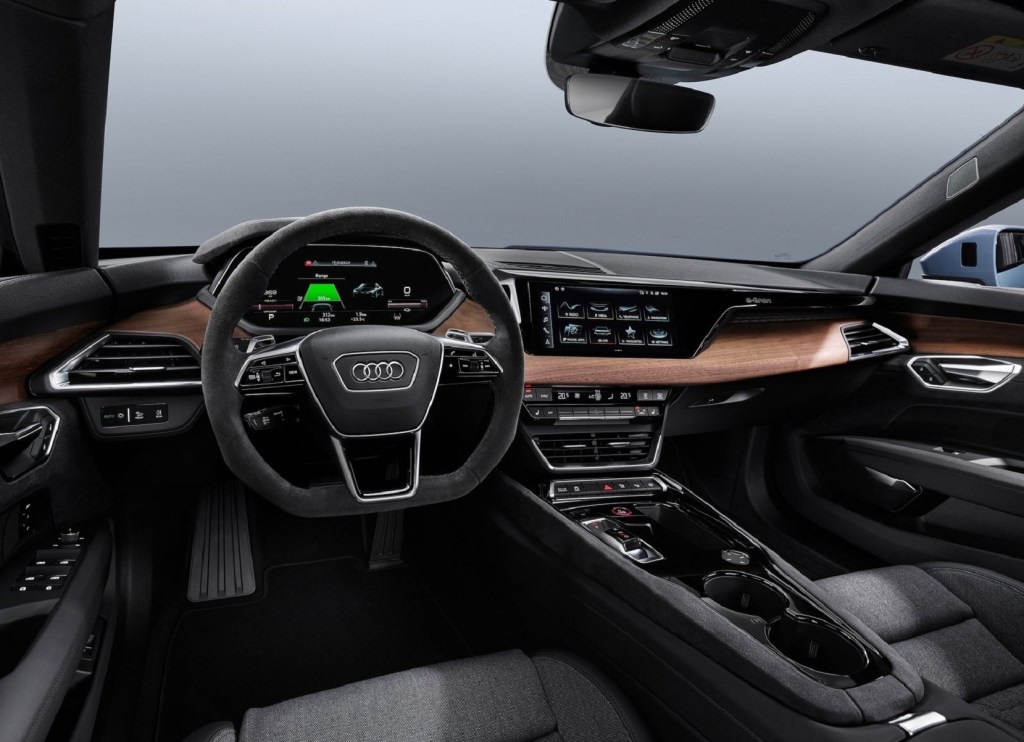 The black front seats and brown-wood dashboard of the 2022 Audi E-Tron GT Quattro