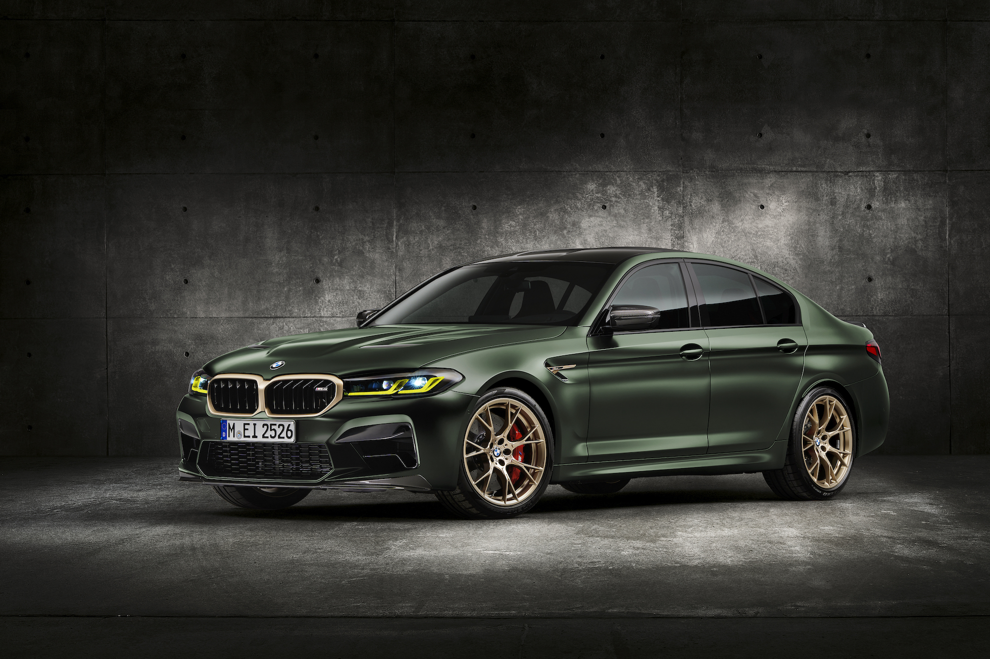 A dark-green 2022 BMW M5 CS with gold accents