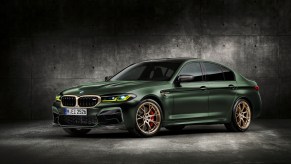 A dark-green 2022 BMW M5 CS with gold accents