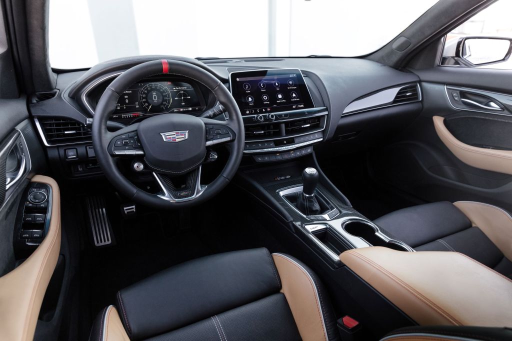 The leather-upholstered tan-and-black front seats and dashboard of the 2022 Cadillac CT5-V Blackwing