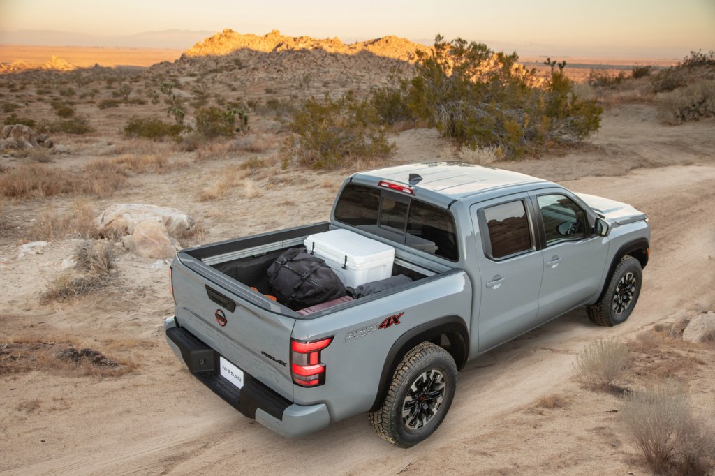 A light gray 2022 Nissan Frontier with a full truck bed shot from above