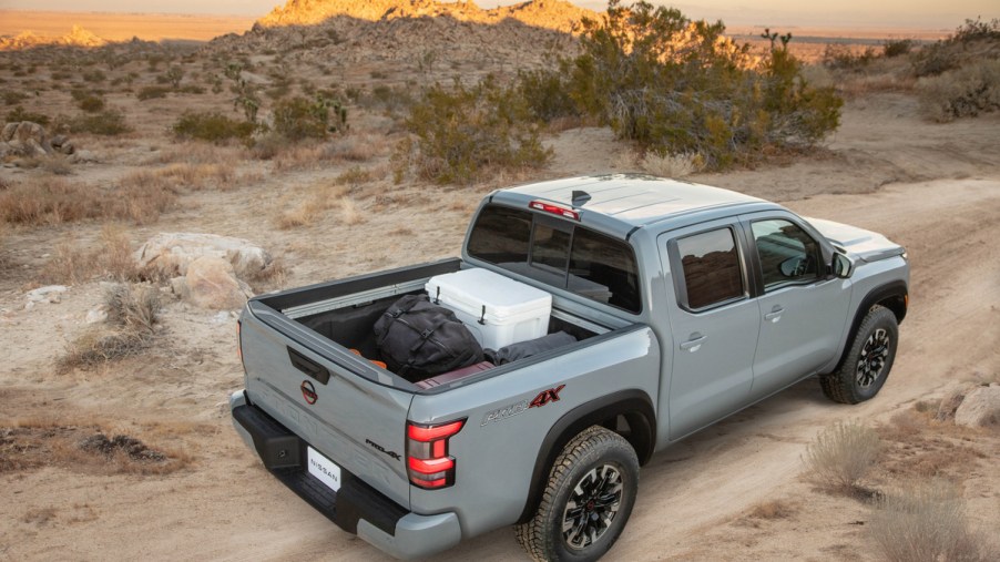 an elevated view of a loaded 2022 Nissan Frontier truck bed as it drives off-road through the desert