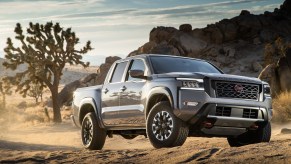 The 2022 Nissan Frontier driving through dirt