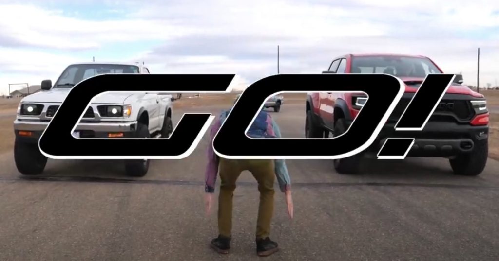 first-gen toyota tacoma pickup truck and the 2021 Ram 1500 TRX about to take off in a drag race
