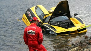 An image of a Ferrari Enzo FXX stuck in a lake.