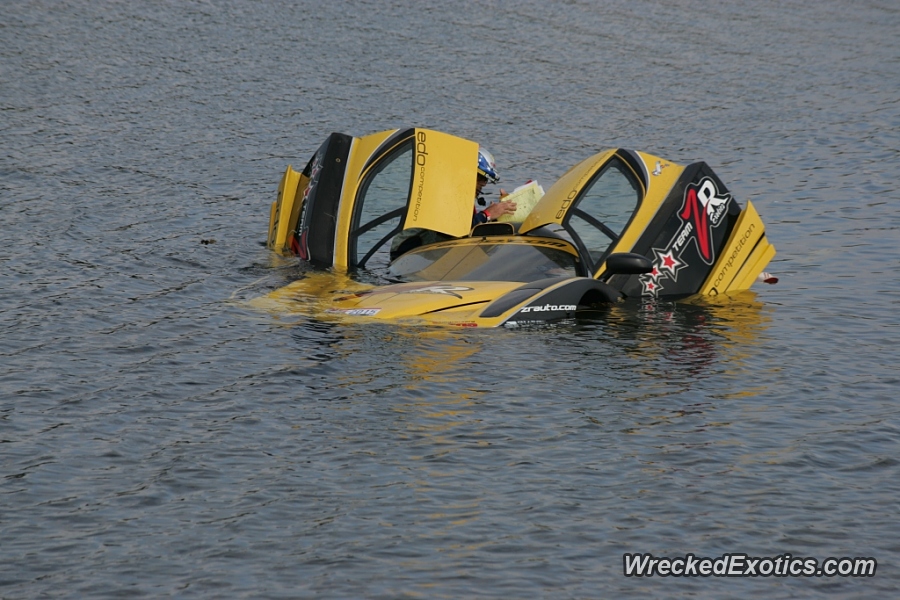 An image of a Ferrari Enzo FXX stuck in a lake.