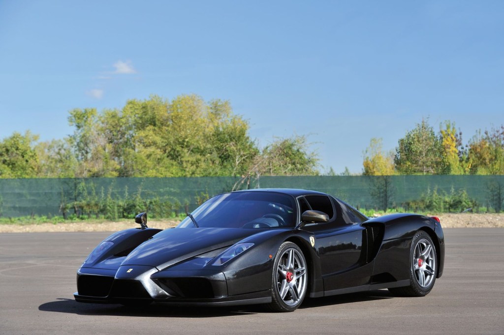 An image of a black Ferrari Enzo parked outside.