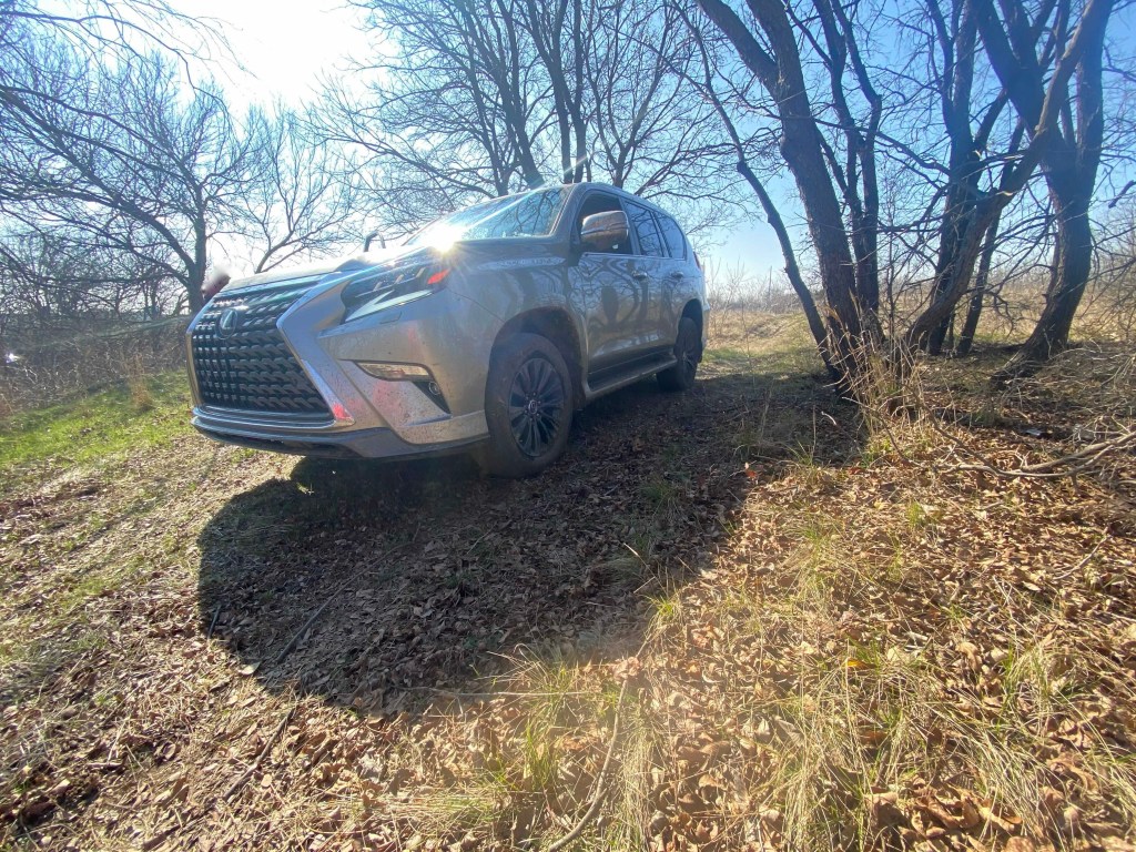a metallic gray 2021 Lexus GX crawling down a muddy hill on wintery off-road trails. 