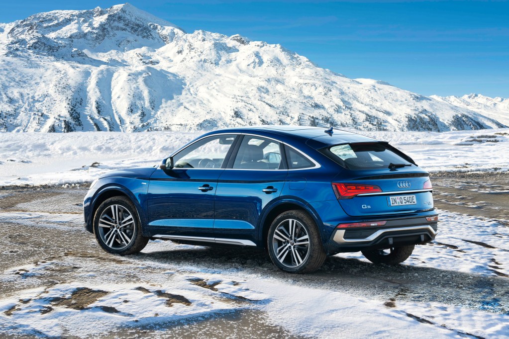A 2021 Audi Q5 Sportback 55 TFSI e quattro in Navarra blue parked on an icy landscape