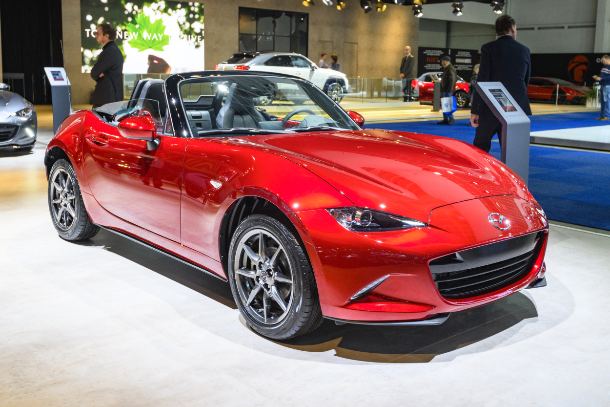 A red Mazda MX-5 Miata on display at an auto show
