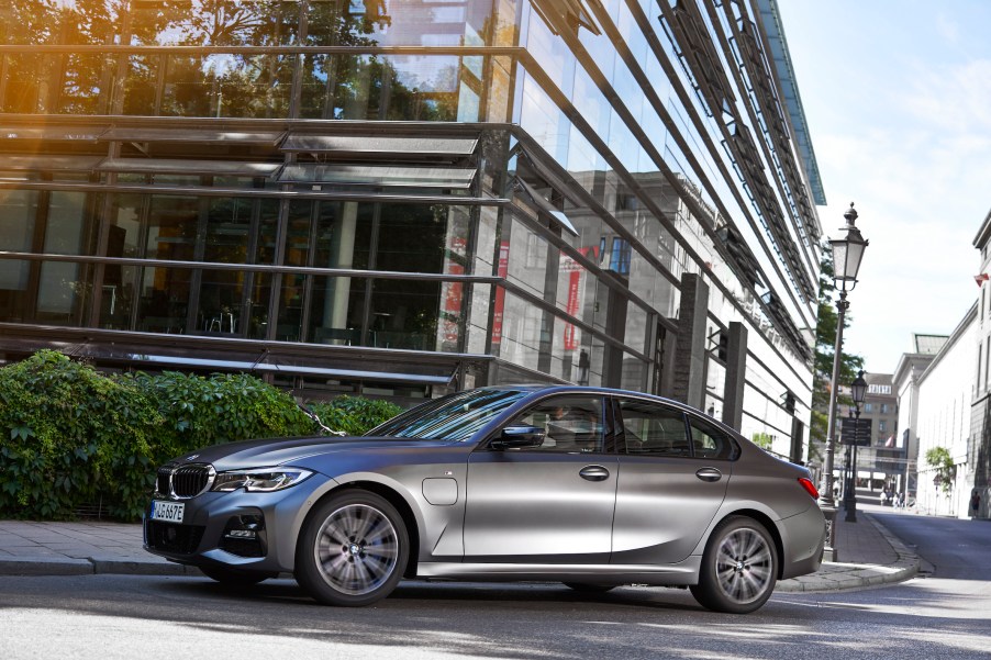 The 2021 BMW 530e parked in front of high-rise buildings on the street