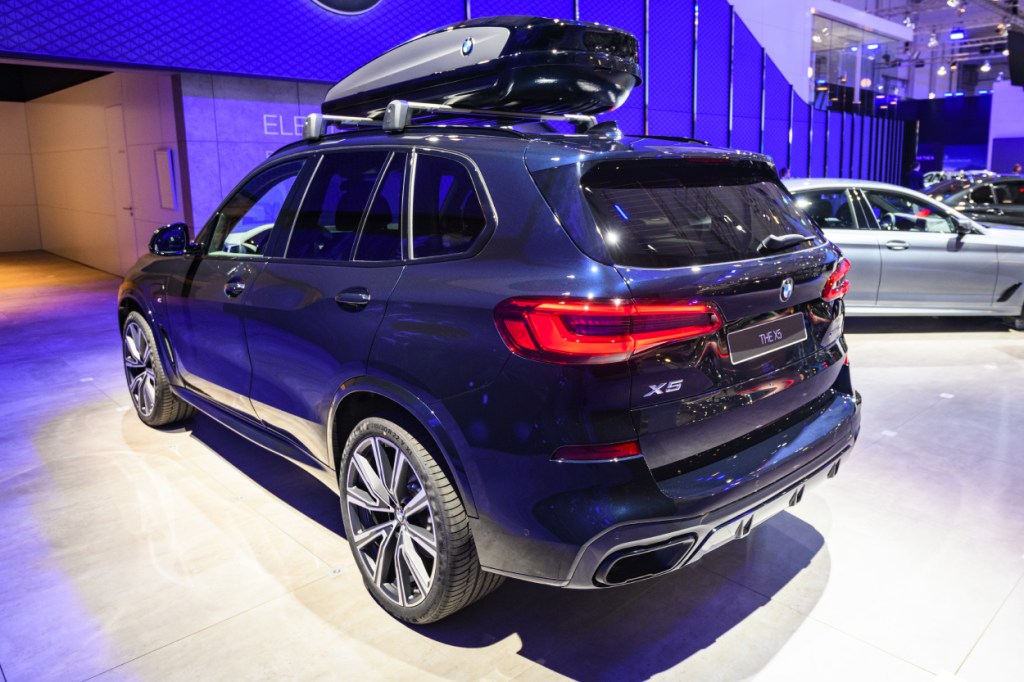 A blue BMW X5 SUV on display at an auto show