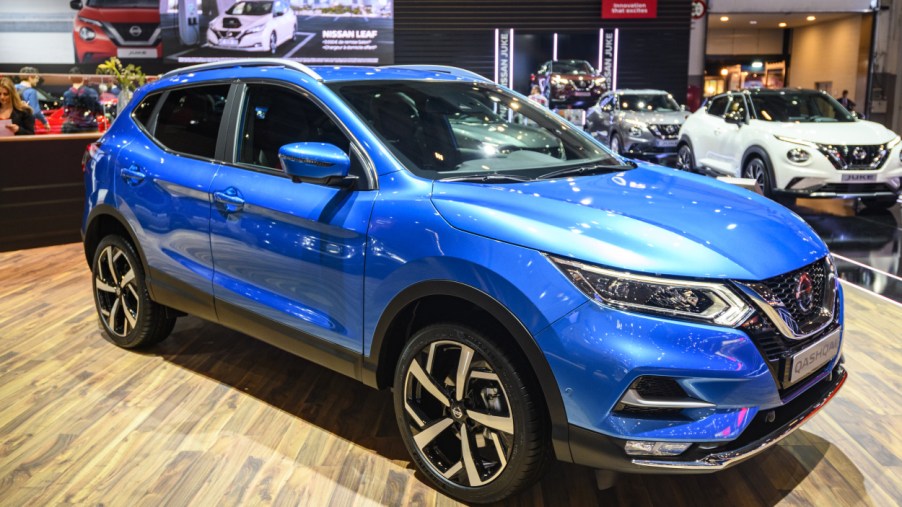 A blue Nissan Rogue on display at an auto show