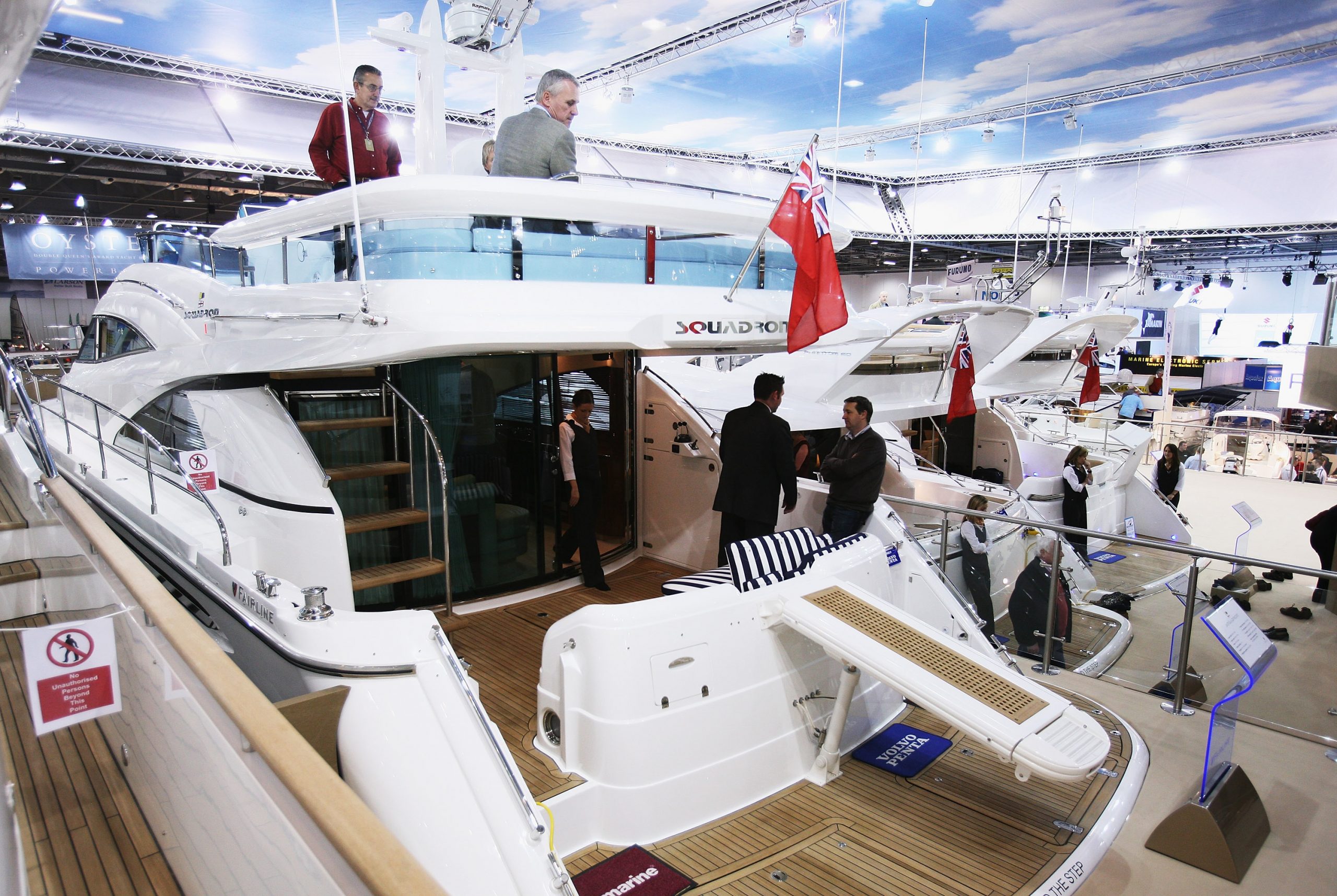 Potential buyers walk around a boat during show