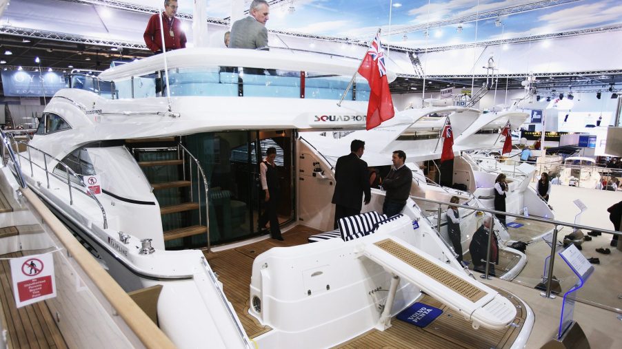 Potential buyers walk around a boat during show