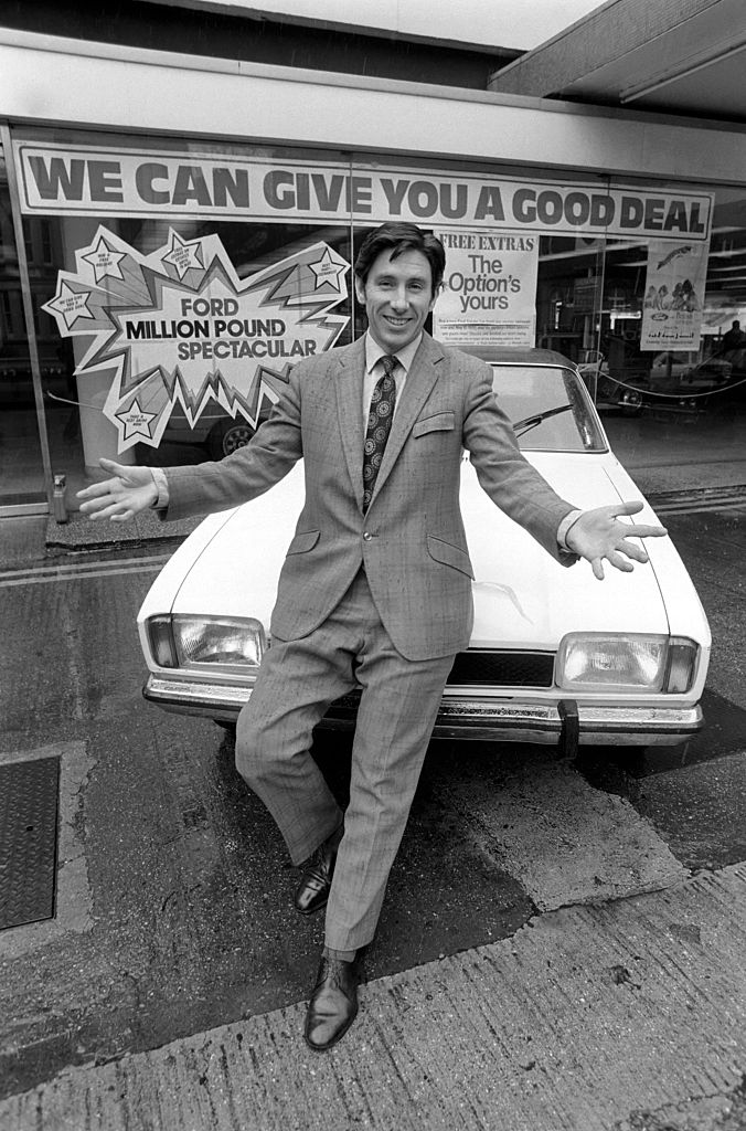 Shady-looking car salesman in black and white image