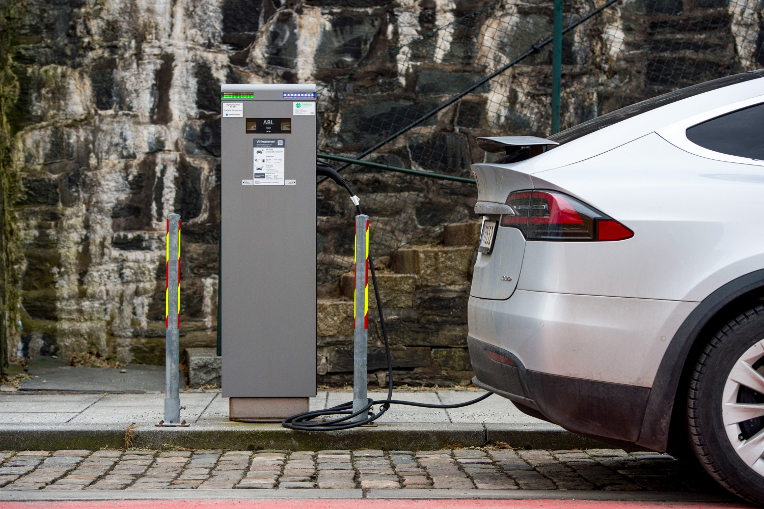 A Tesla is plugged in to an electric vehicle charger in Stavanger, Norway