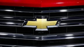 A close-up of Chevy's bow-tie logo on the grille of a car