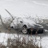 A Subaru Forester sinking through a frozen lake