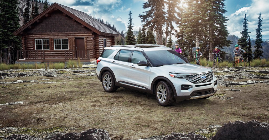 The 2021 Ford Explorer parked in front of a cabin