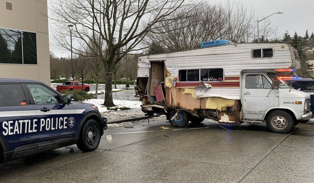 the Seattle Police Department spaud car squaring off with the RV driver in the middle of the street