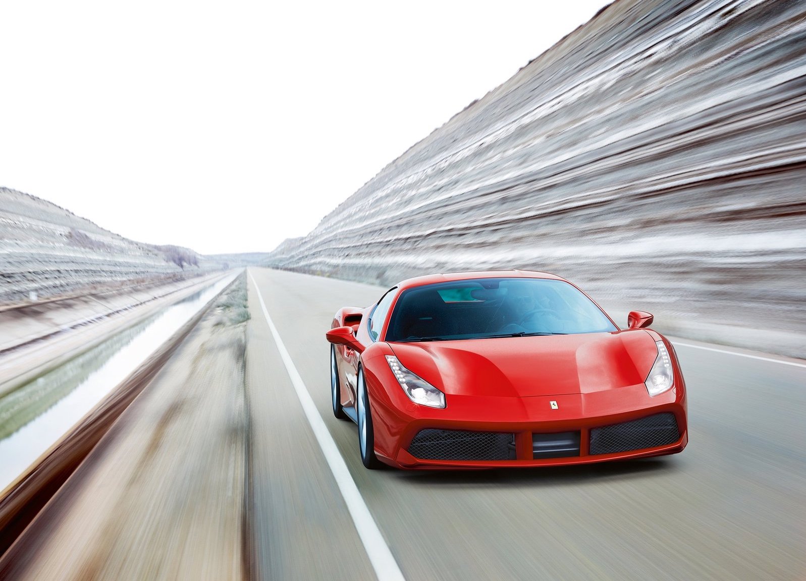 An image of a red Ferrari 488 GTB on a race track.