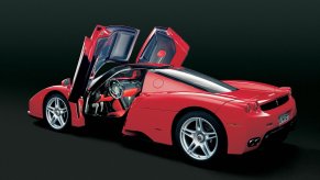 A digital image of a Ferrari Enzo in a black studio.